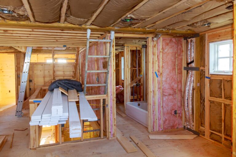 Unfinished room under renovation with exposed insulation in the walls